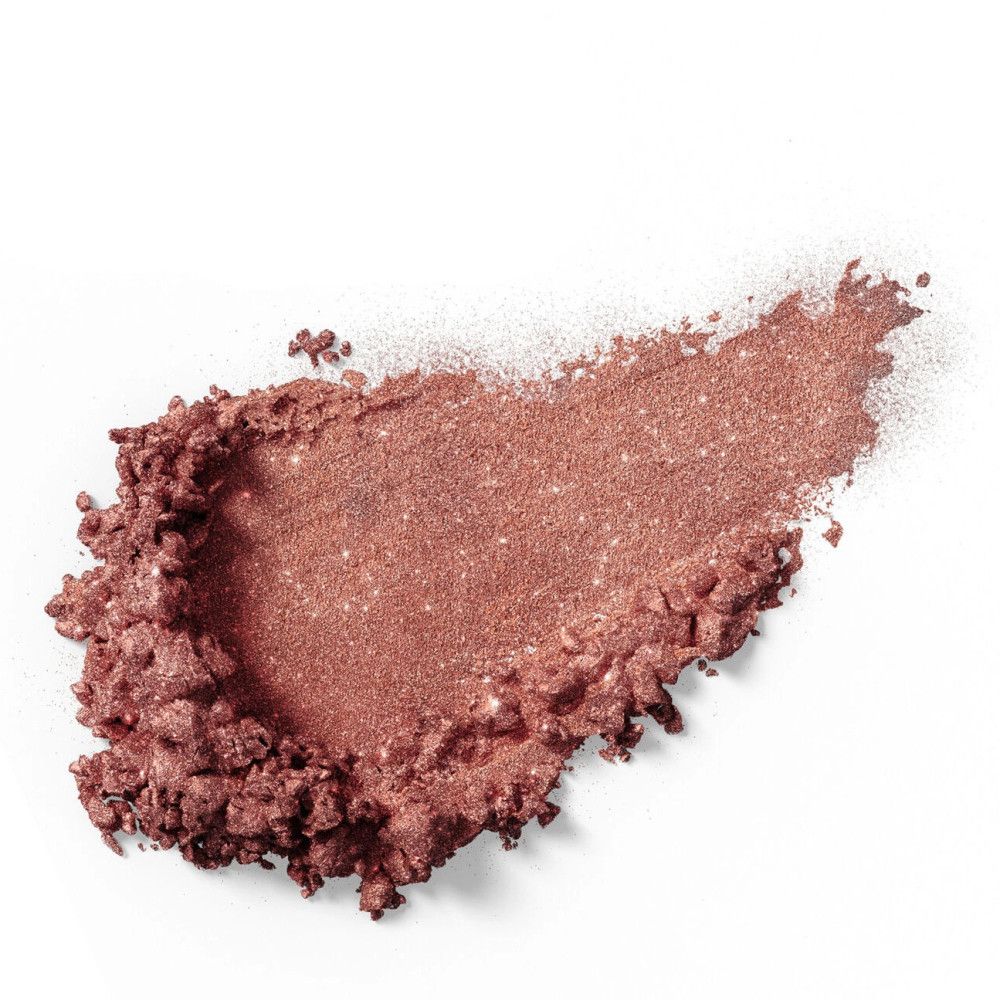 Hoop roze oogschaduw uitgesmeerd op een wit oppervlak. De textuur is glanzend.