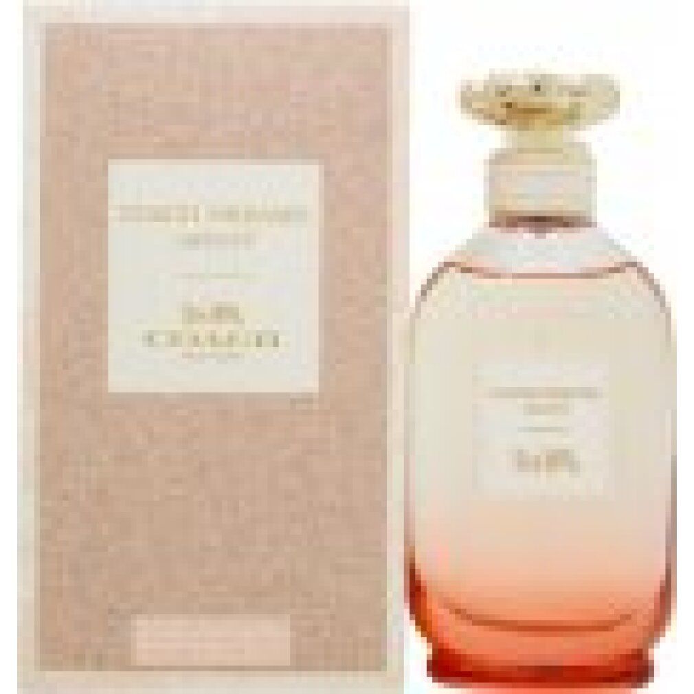 Flacon de parfum et emballage. Inscription: Coach Dreams Sunset. Emballage rose. Flacon dégradé.