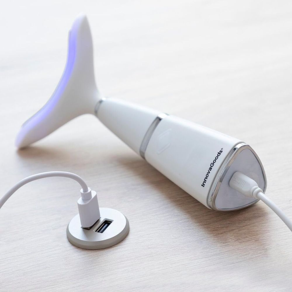 Appareil blanc avec tête incurvée, port USB et câble de charge. Logo InnovaGoods.