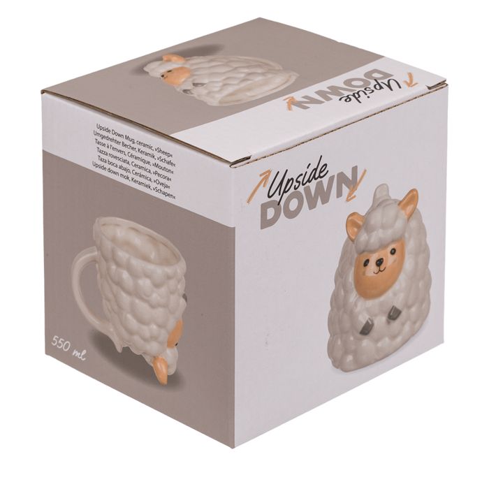 Keramische beker schaap in verpakking. Opschrift "Upside Down". Schaap-ontwerp met oren, gezicht en poten. Verpakking met afbeelding en tekst.
