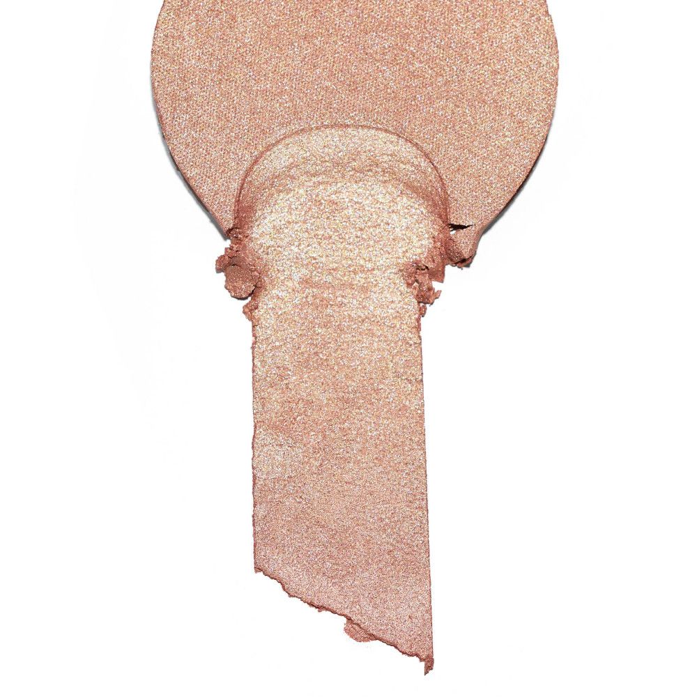 Highlighter-veeg in druppelvorm. Goudkleurige glans. Product is afgebroken.