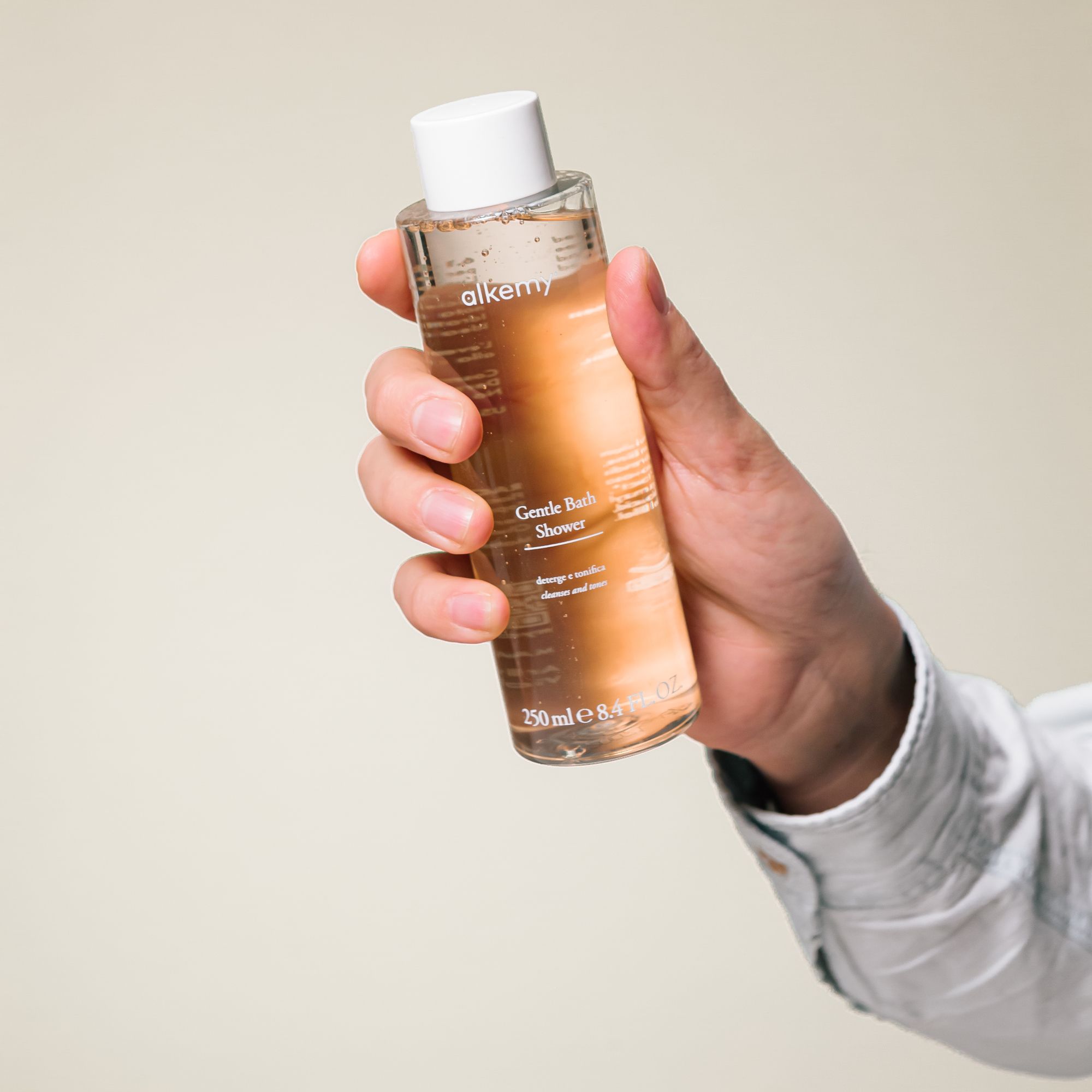 Gel douche Alkemy dans une bouteille transparente avec bouchon blanc, 250ml.