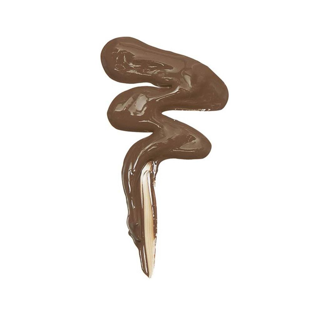 Nuance de correcteur brun en forme de vague. Applicateur visible.