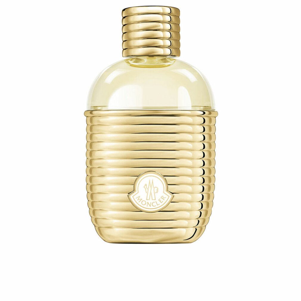 Flacon doré avec surface cannelée et logo Moncler. Bouchon et col également dorés. Contenu transparent et jaunâtre.