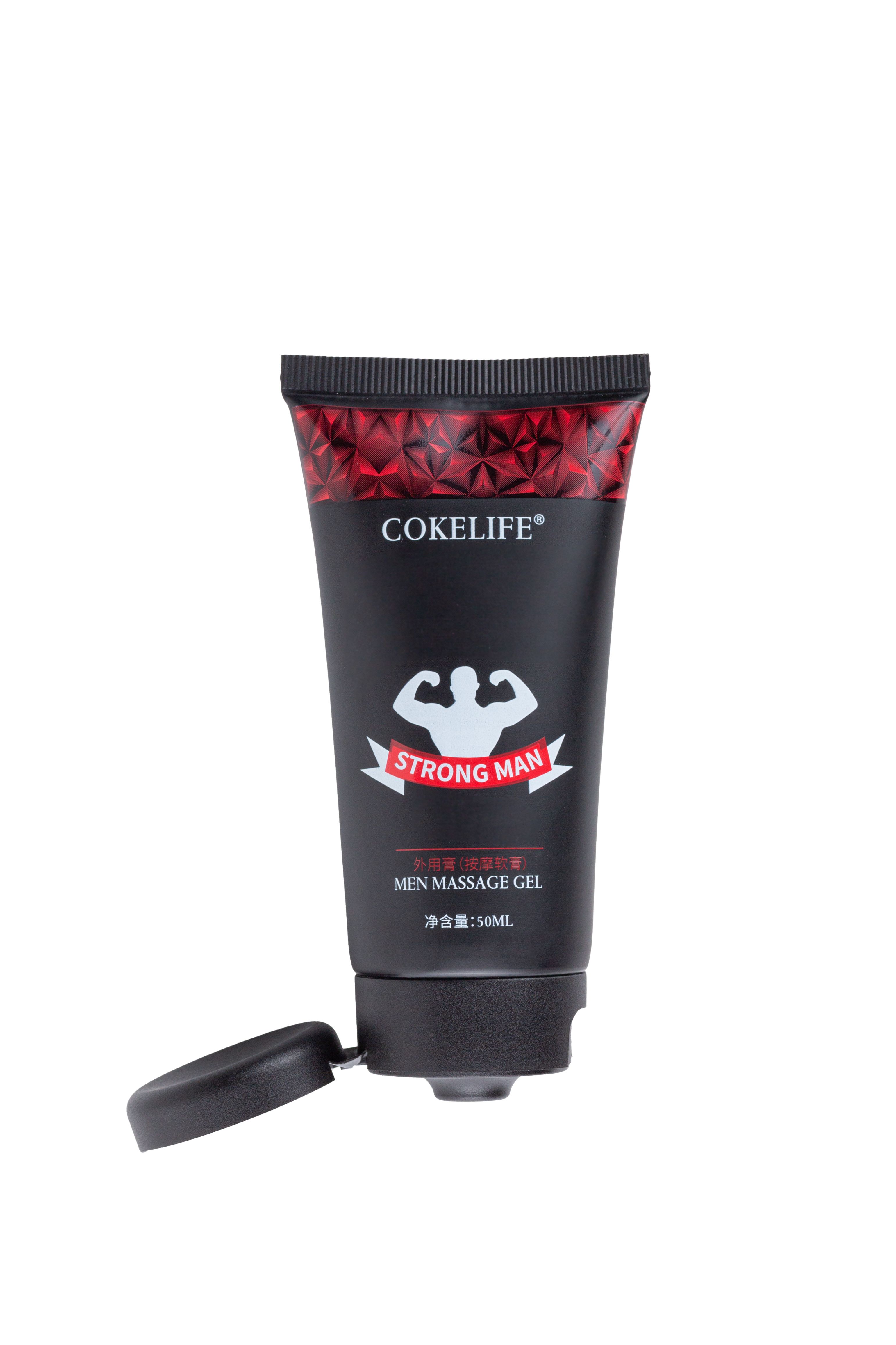 Tube noire avec motif rouge et texte. Bouchon ouvert. Texte: COKELIFE, STRONG MAN, MEN MASSAGE GEL.