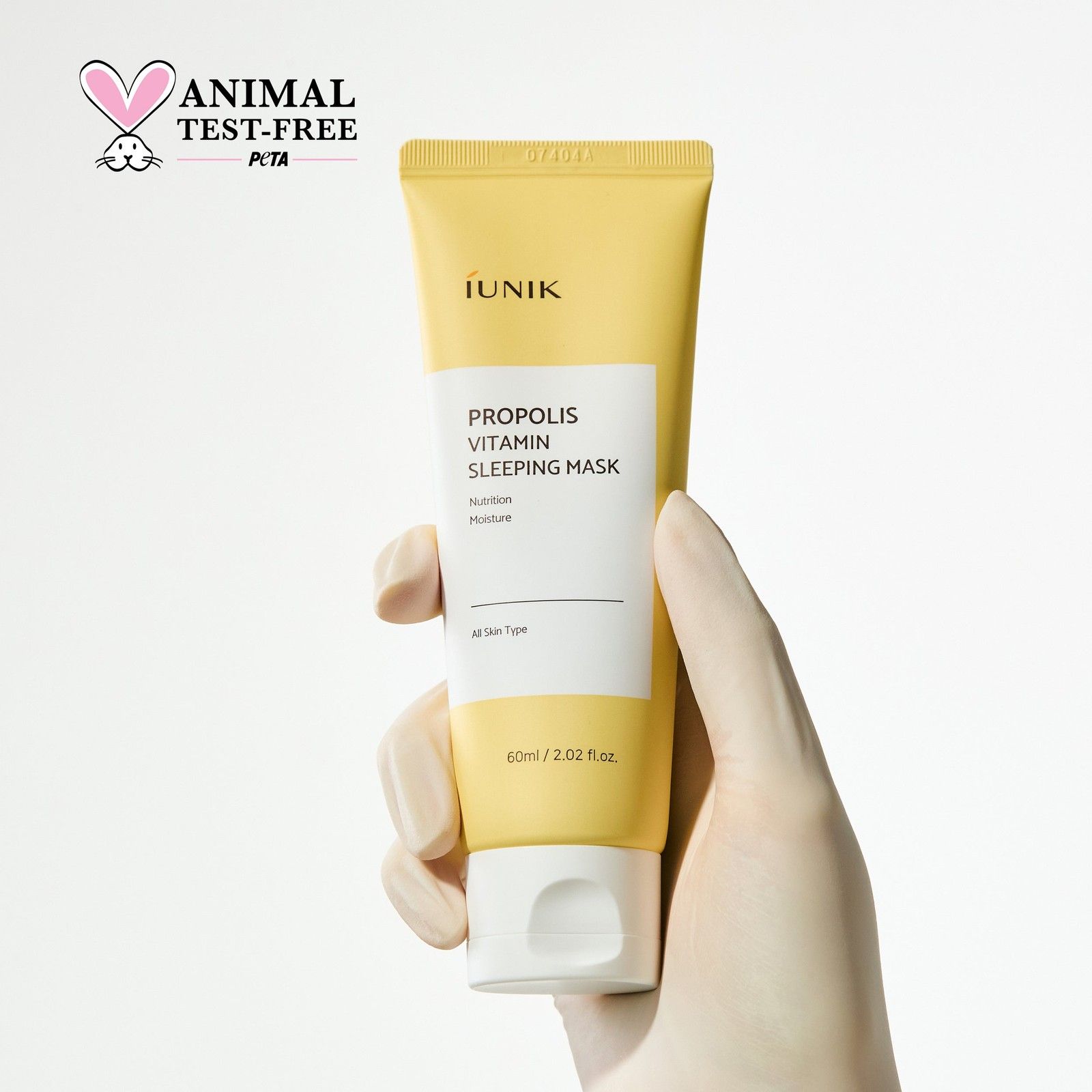Main tenant le tube de masque de nuit Propolis Vitamine iUNIK avec sceau PETA.