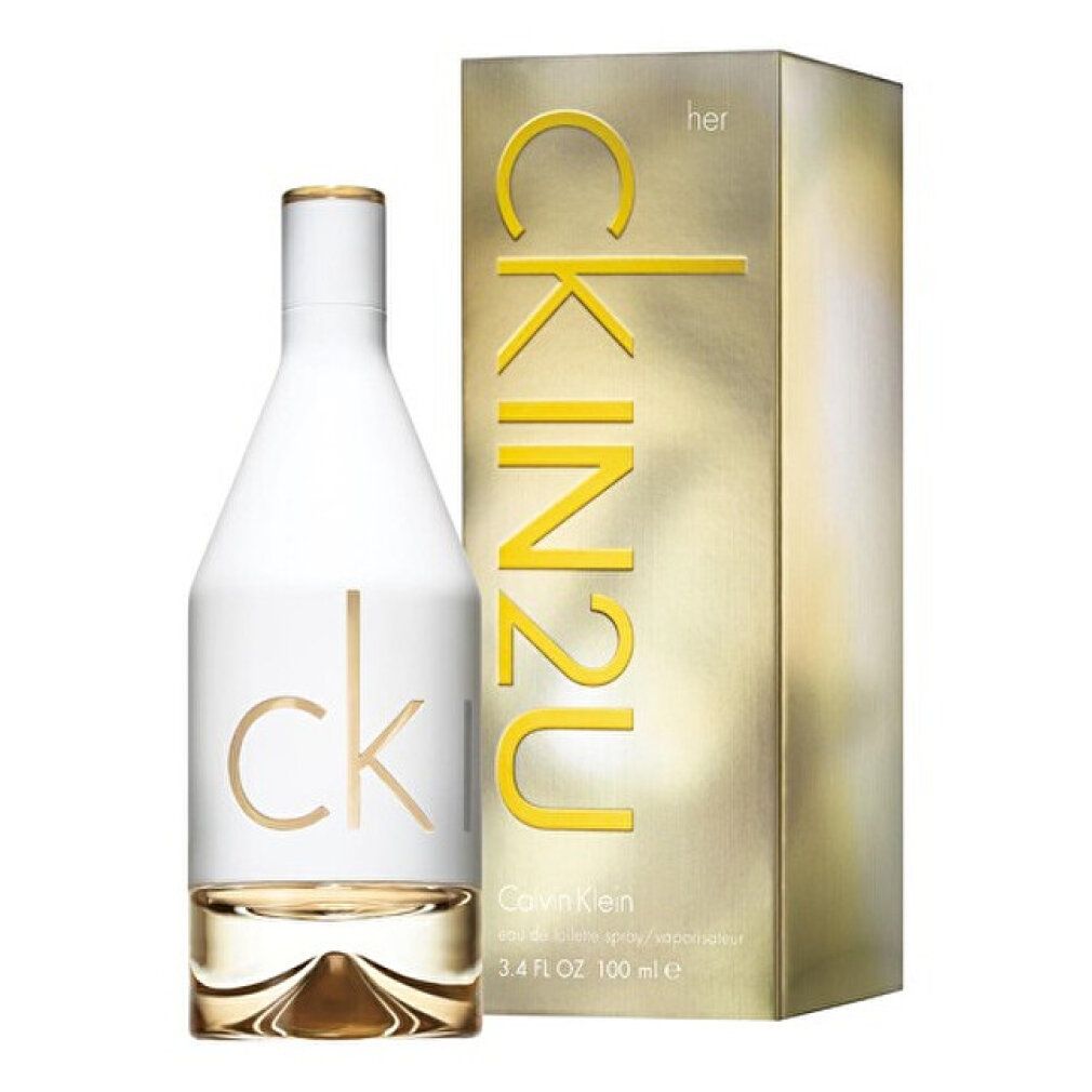 Flacon et emballage de parfum. Flacon blanc, inscription CK IN2U dorée. Emballage doré avec inscription CK IN2U.