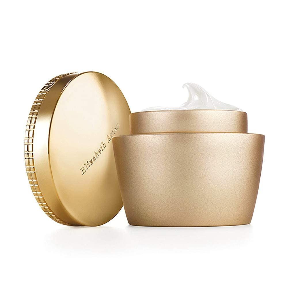 Pot doré avec couvercle ouvert. Le couvercle est à côté. Crème visible. Elizabeth Arden est écrit sur le couvercle.
