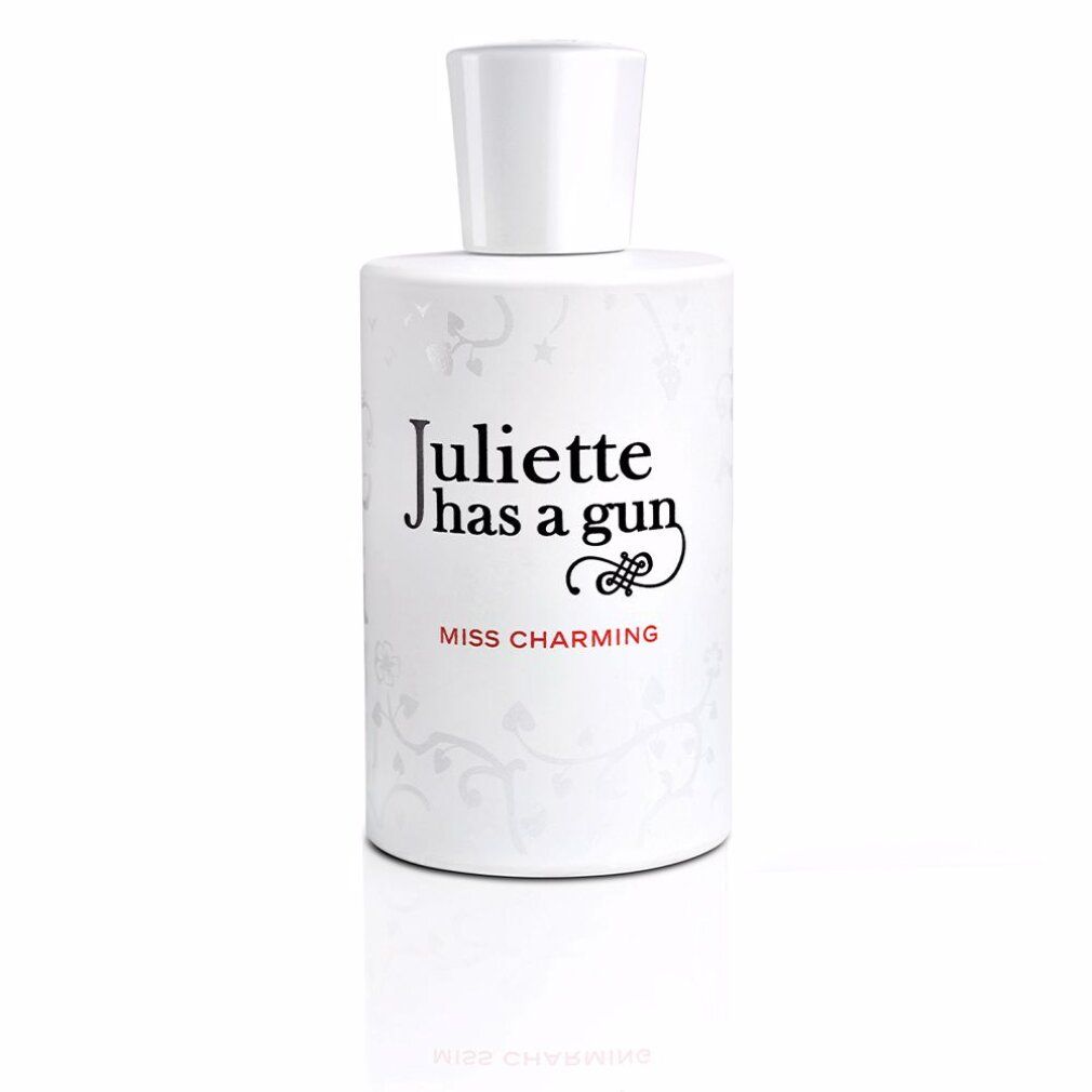 Witte parfumfles. Opschrift: Juliette Has a Gun, Miss Charming. Witte dop.