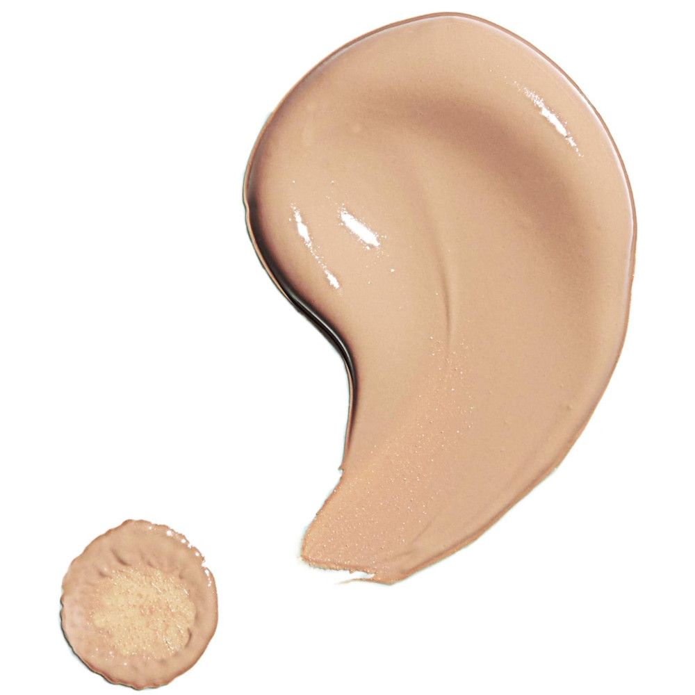 Vlek concealer. Lichtbruine tint. Daarnaast een kleinere vlek met sponsapplicator.