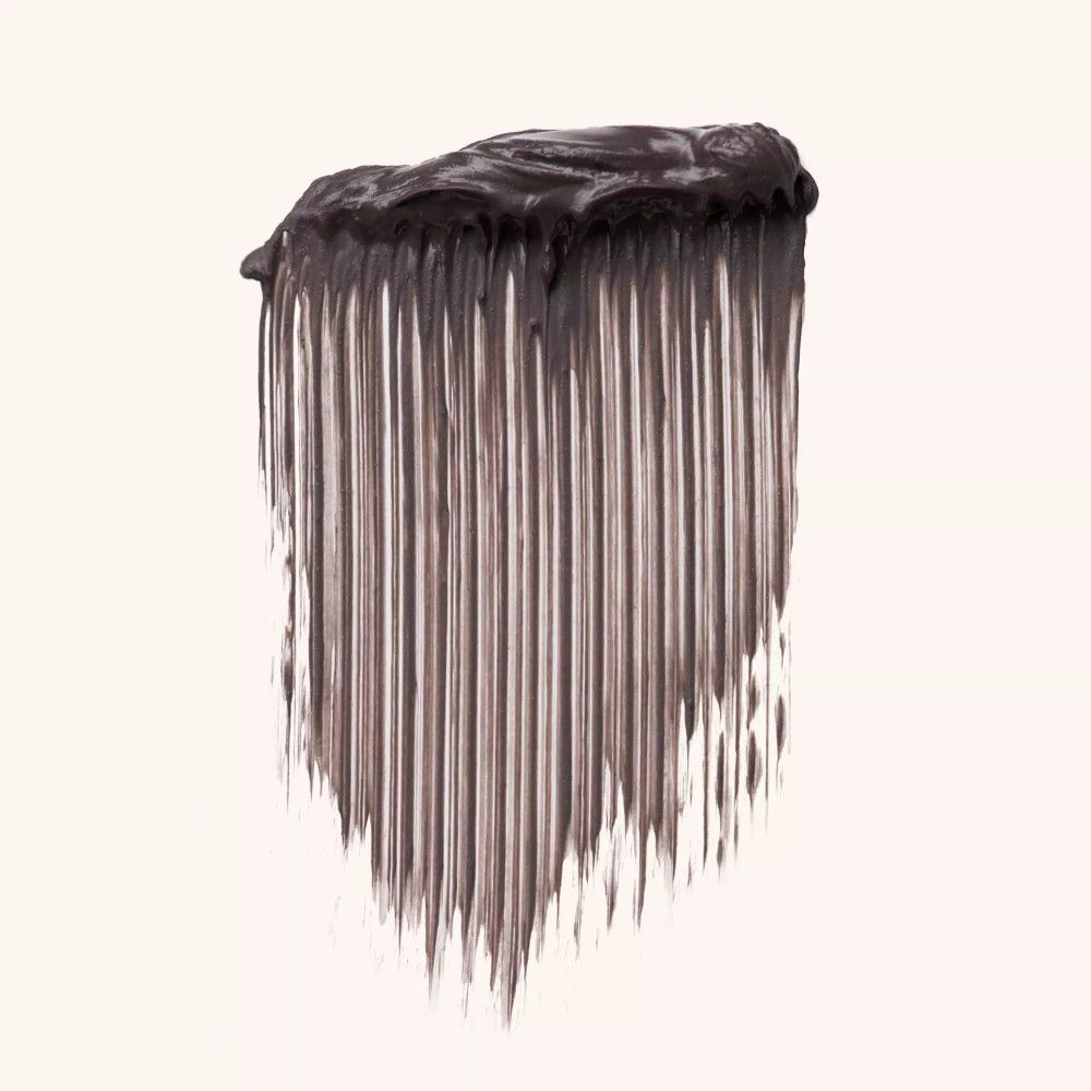 Wenkbrauwgel mascara veeg. Donkerbruine kleur. Textuur met borstelharen. Op lichte achtergrond.