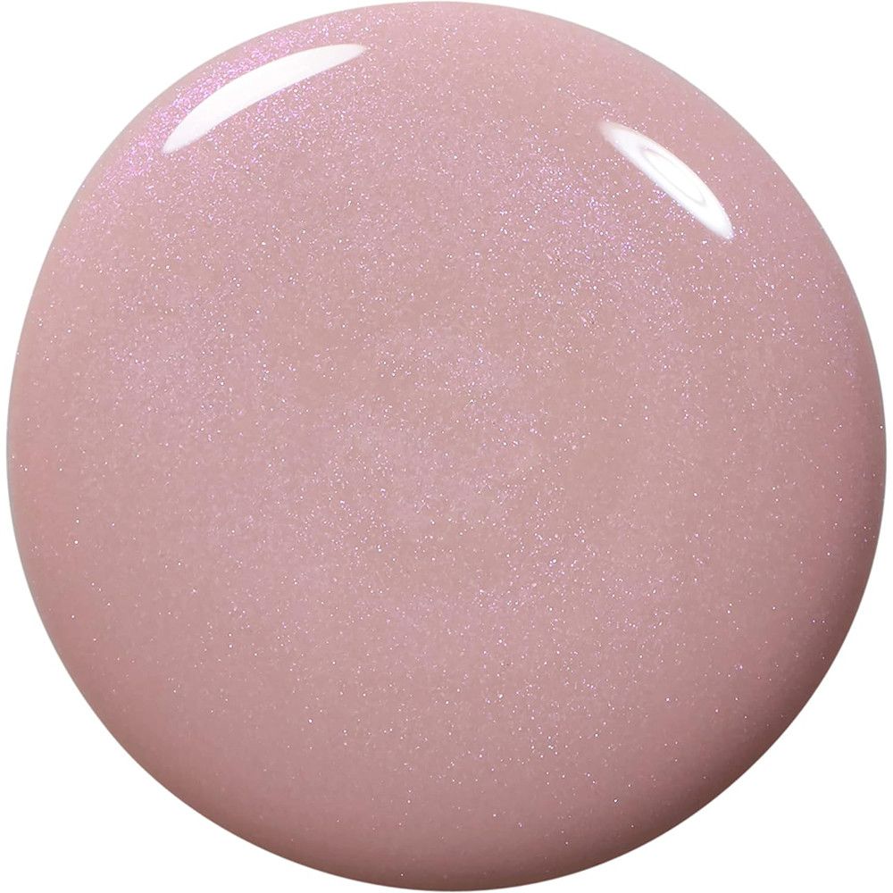 Un échantillon rond de vernis à ongles rose pâle avec un léger scintillement.