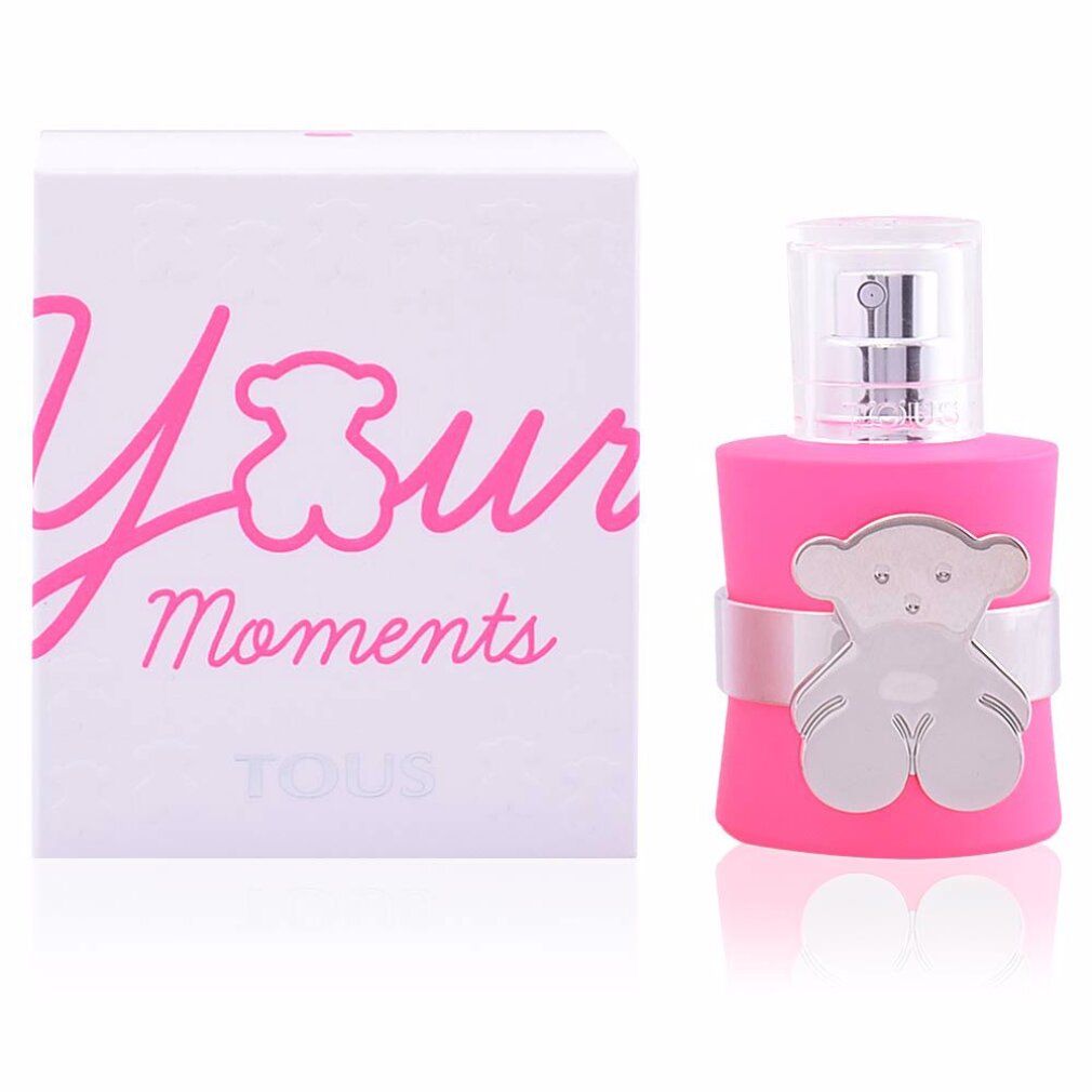 Roze fles met zilveren beerdecoratie en witte verpakking met opschrift "Your Moments".