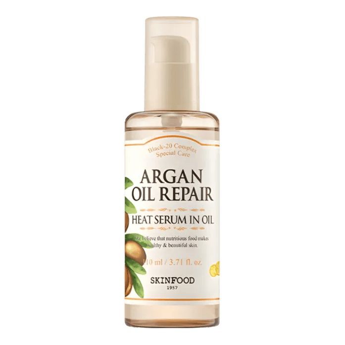 Flacon de sérum. L'étiquette indique "ARGAN OIL REPAIR HEAT SERUM IN OIL". En dessous, on lit "SKINFOOD".