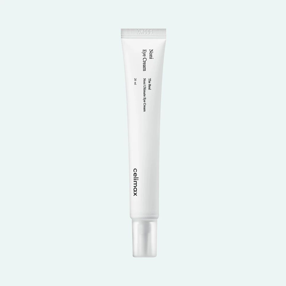 Witte tube met tekst. Merk: celimax. Productnaam: Noni Eye Cream. Tekst in het Engels.