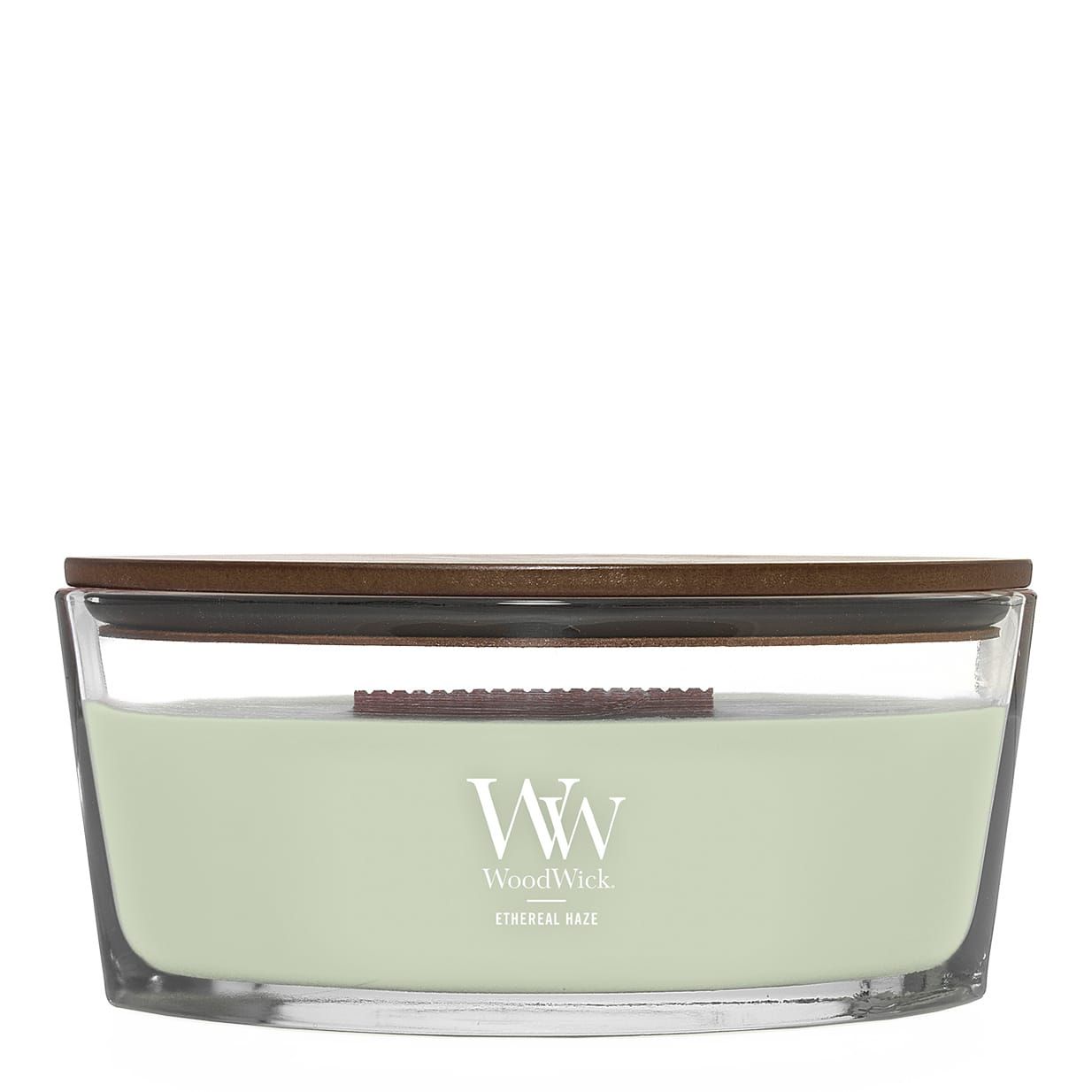 Ellipse kaars met houten deksel. Groene was in glazen houder. 'WW' logo. Opschrift 'Ethereal Haze'.