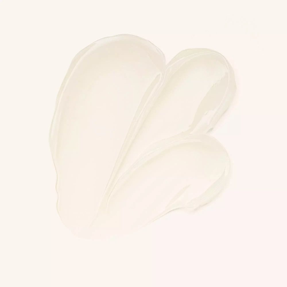 Crèmetextuur, lichtbeige, in golvende streken op lichte achtergrond. Producttextuur.