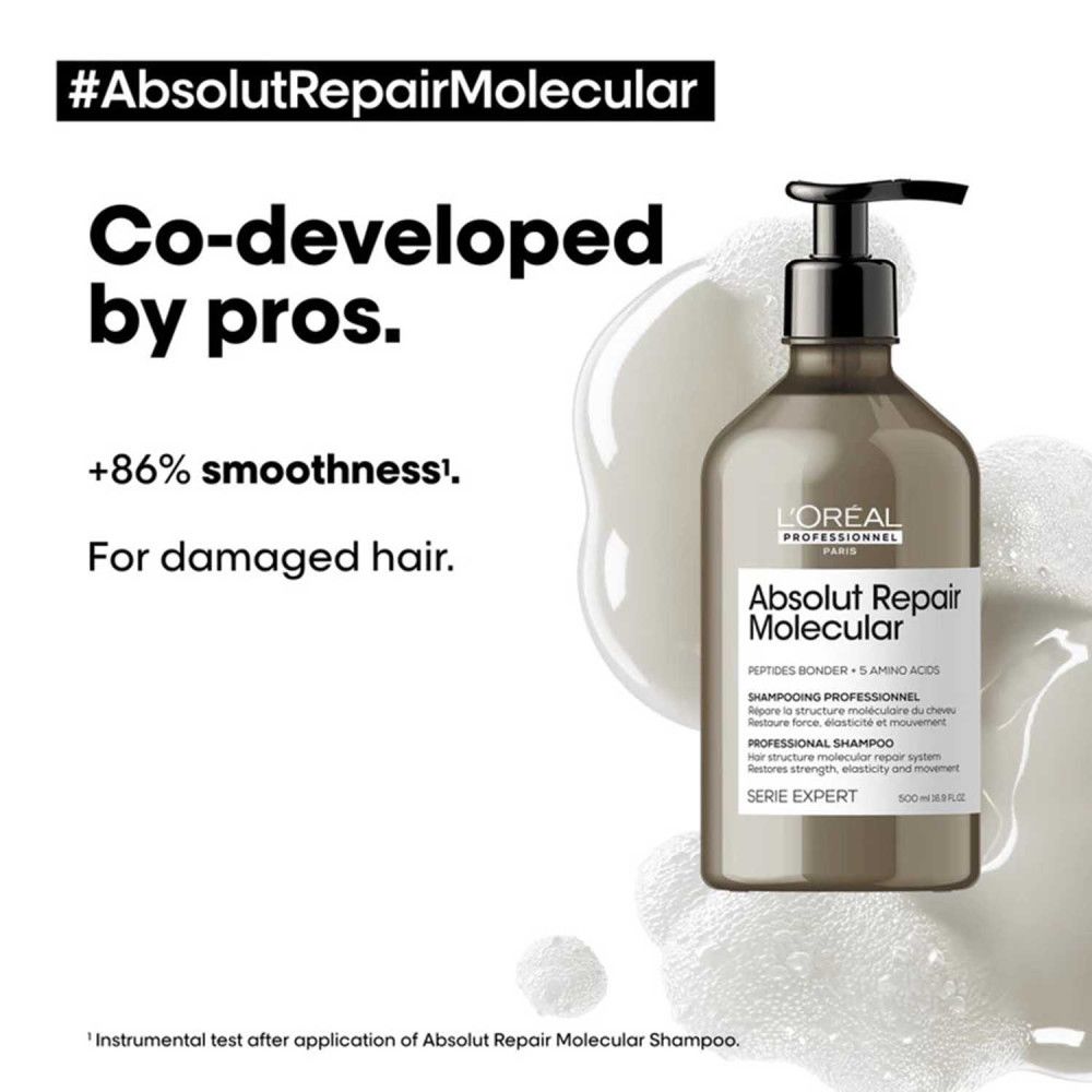 Shampoing L'Oréal Professionnel Absolut Repair Molecular avec pompe, entouré de mousse.