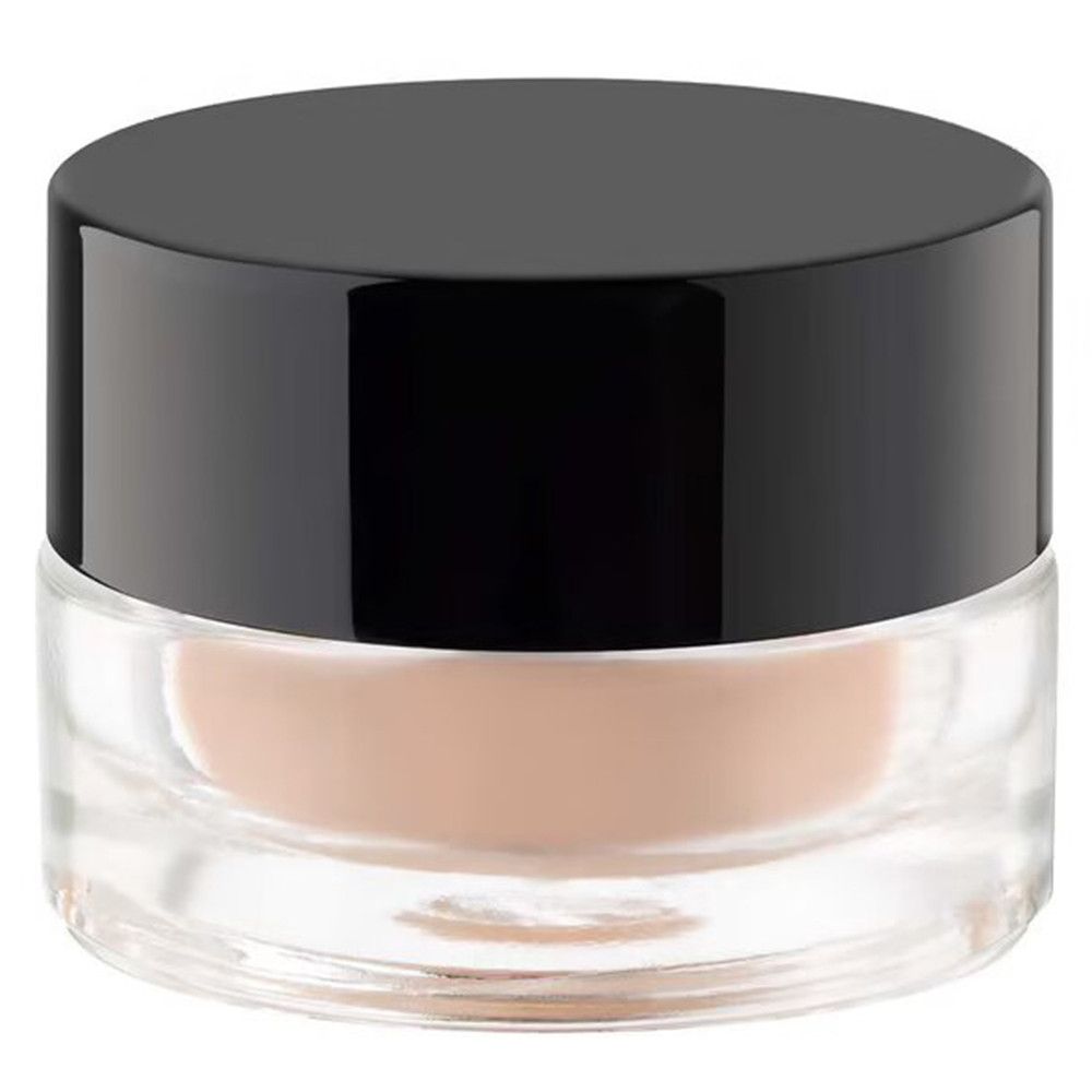 Ronde pot met zwart deksel. De pot is van transparant glas. Inhoud: beige crème.