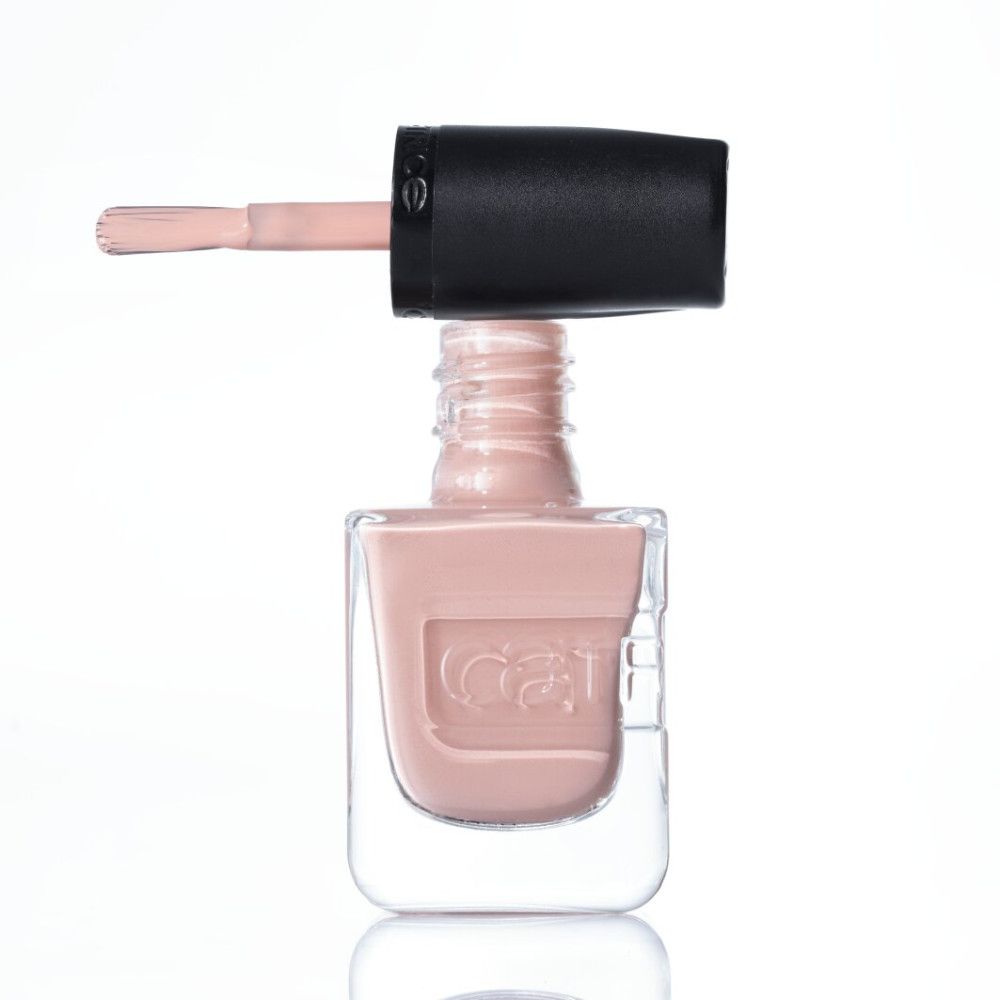 Een lichtroze nagellak in een doorzichtig flesje met zwarte dop en kwastje.