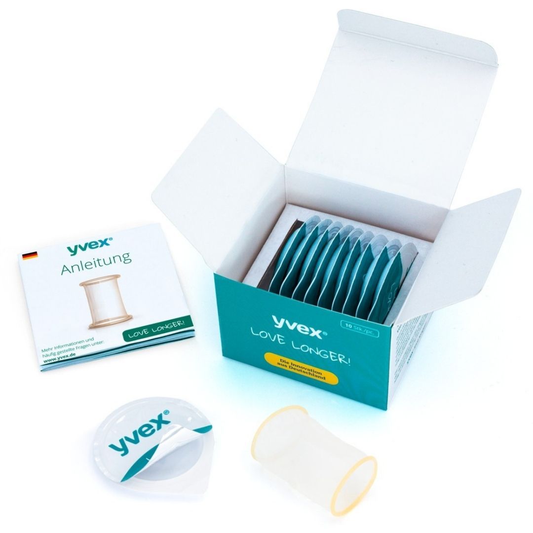 Open productverpakking met meerdere individuele verpakkingen. Instructies en product. Opschrift "yvex LOVE LONGER!".