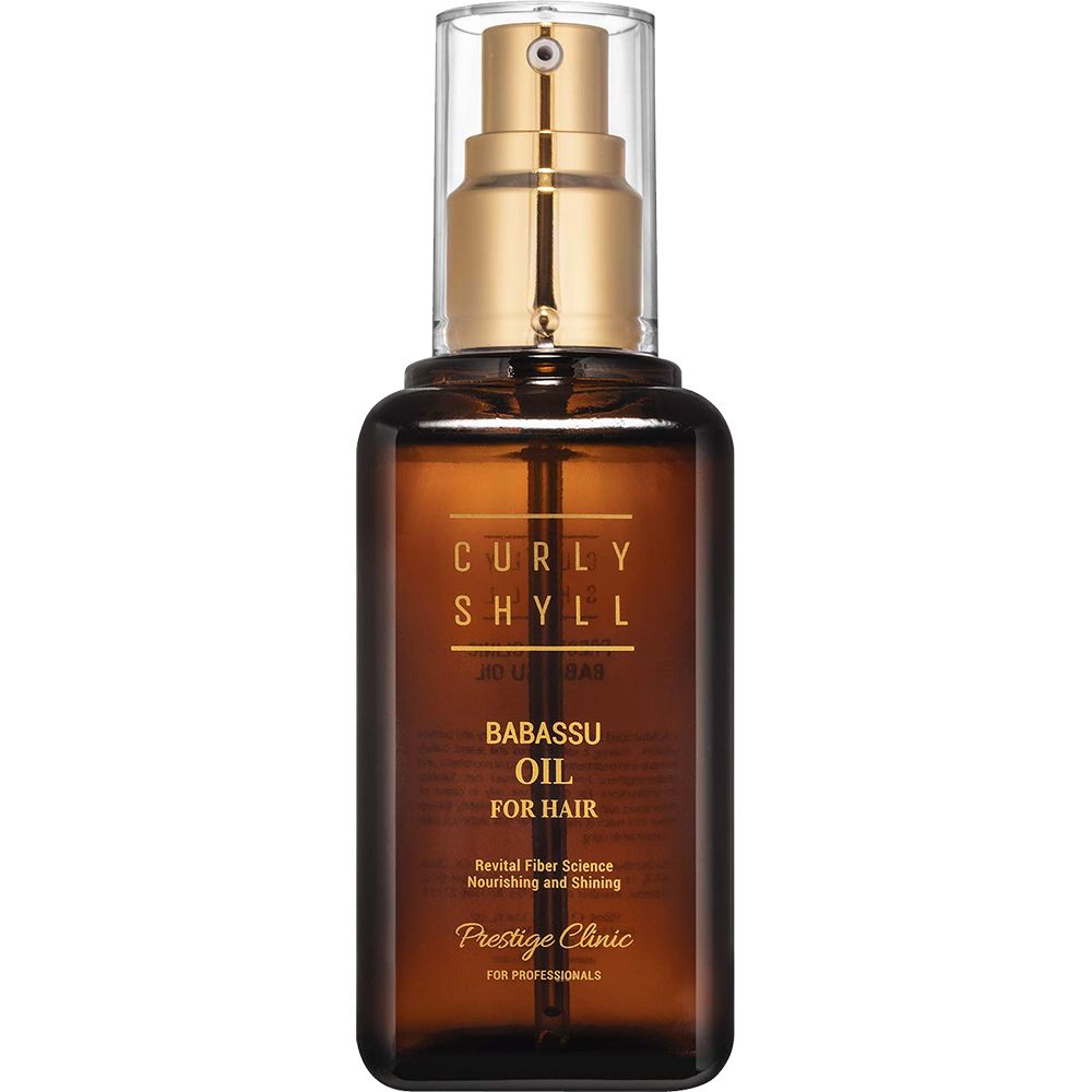 Bruine fles met gouden verstuiver. Opschrift: CURLY SHYLL, Babassu Oil for Hair. Prestige Clinic.