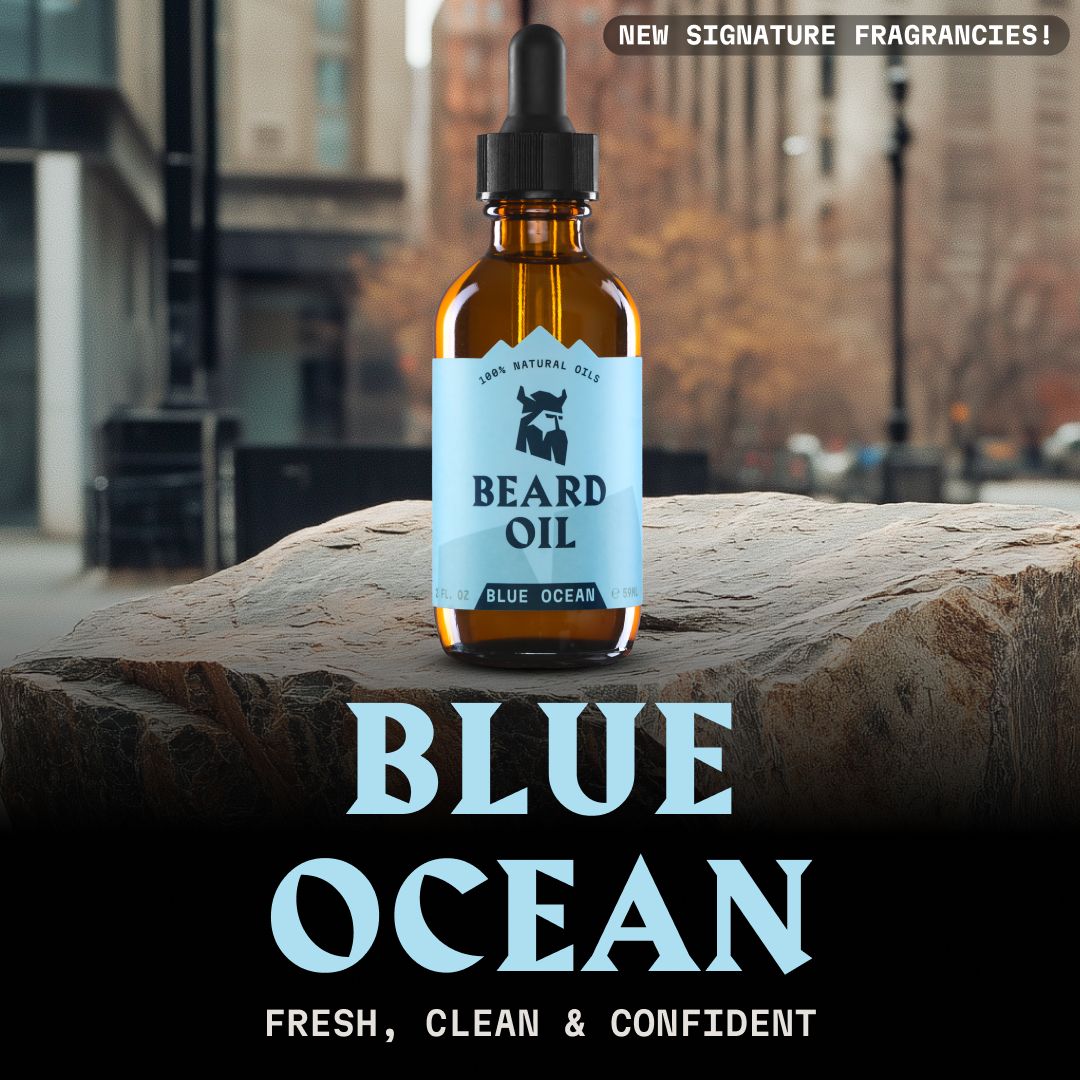 Huile à barbe Striking Viking 'Blue Ocean' en flacon de verre brun avec pipette, sur un rocher devant un paysage urbain.