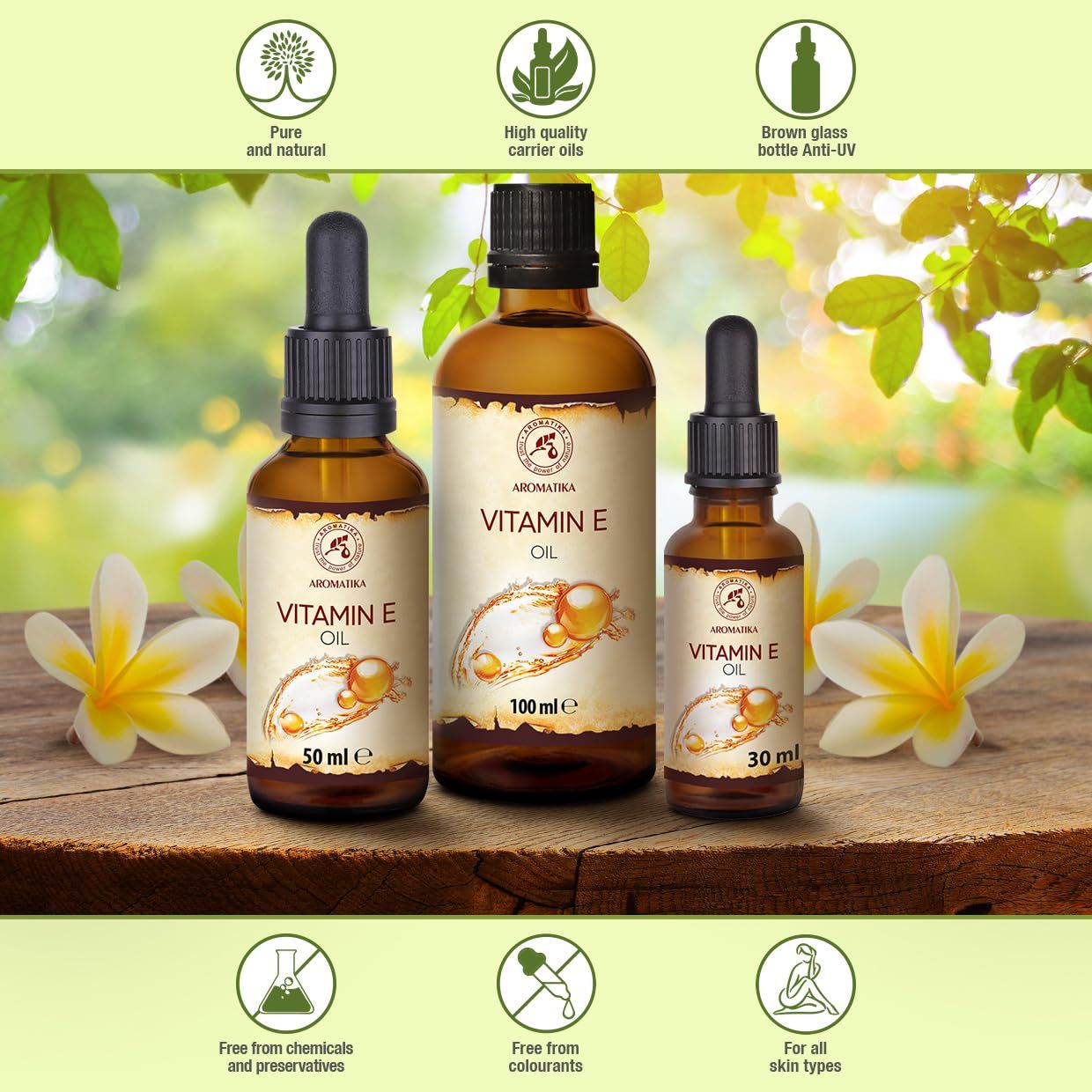 Drie AROMATIKA Vitamine E Olie flessen (30ml, 100ml, 50ml) op hout. Iconen voor zuiverheid en kwaliteit.