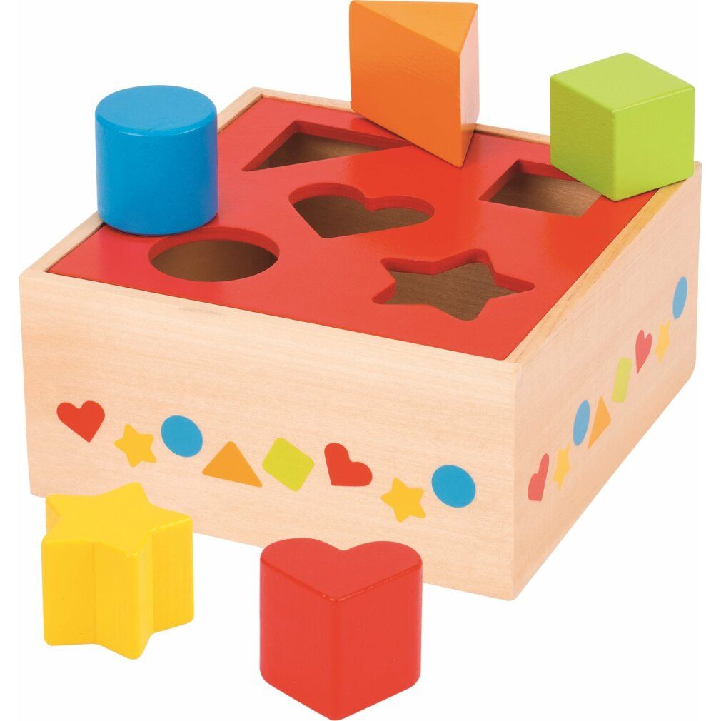Boîte en bois avec formes colorées à insérer. Dessus rouge avec ouvertures. Plusieurs formes à côté.