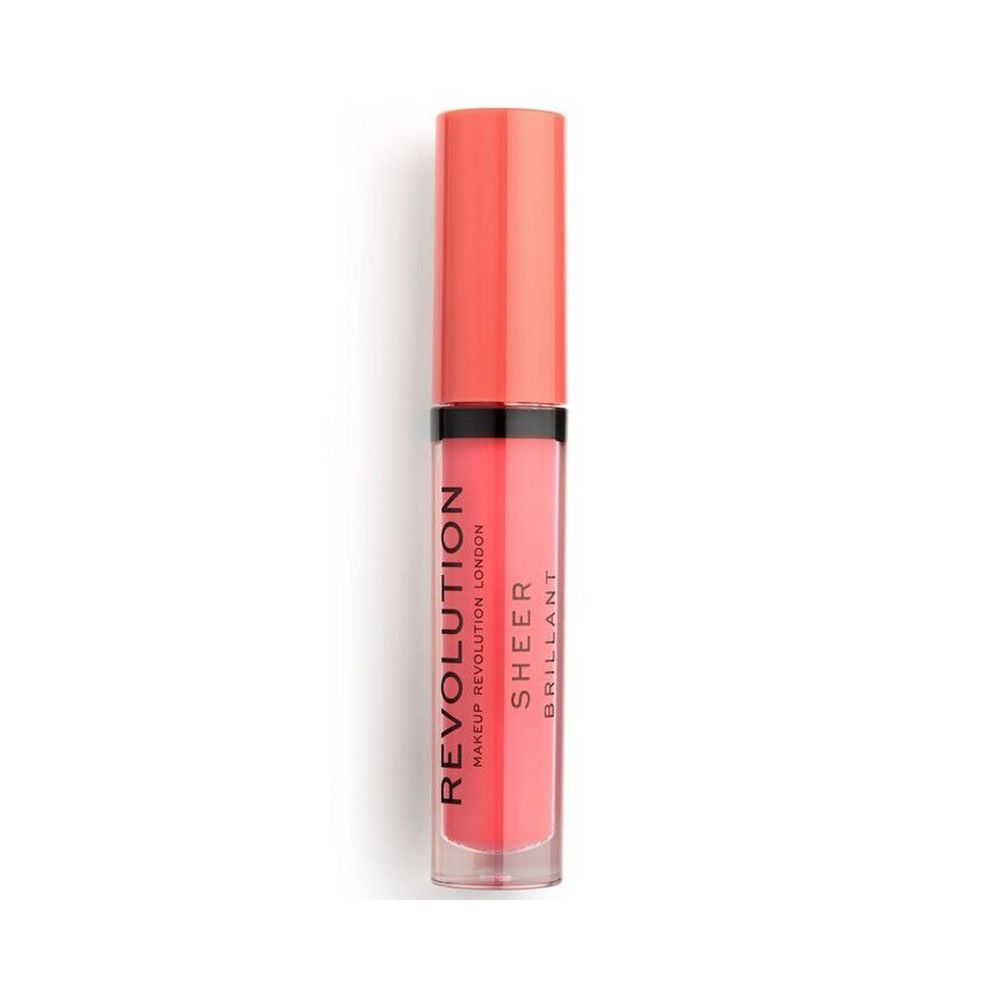 Flacon de gloss fermé. Le gloss est rose. "REVOLUTION LONDON SHEER BRILLANT" est écrit sur le flacon.