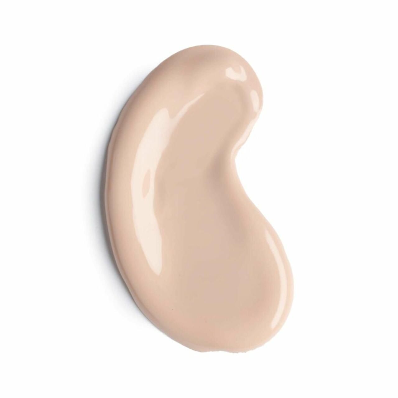 Vlek foundation in licht beige. Vorm: druppelvormig. Glanzend oppervlak.