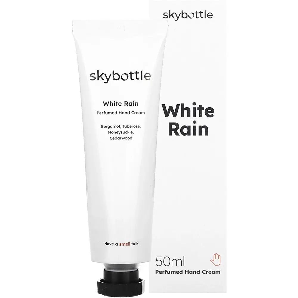 Tube et boîte de crème pour les mains blanches. Inscription : skybottle, White Rain, 50ml. Ingrédients : Bergamote, Tubéreuse, Chèvrefeuille, Bois de cèdre.