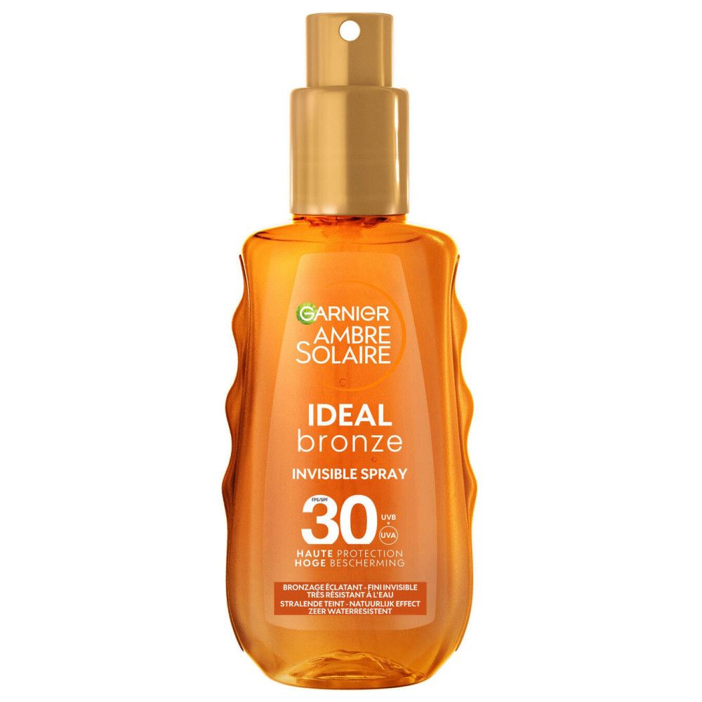 Flacon spray avec tête dorée. Inscription: Garnier Ambre Solaire Ideal Bronze, SPF 30. Liquide orangé visible.