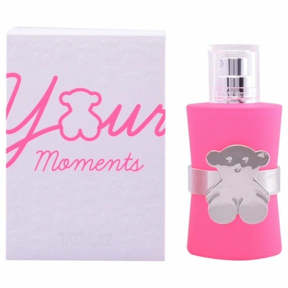 Roze fles met zilveren beerdecoratie en witte verpakking met opschrift "Your Moments".