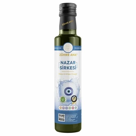 Bouteille en verre vert avec bouchon noir. Inscription Zühre Ana, Nazar Sirkesi. Étiquette avec œil bleu et certifications.