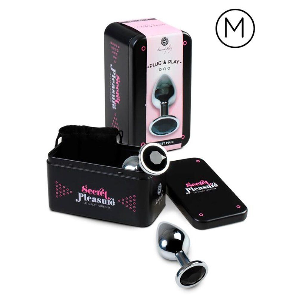 Plug anal en métal avec une large base et des ornements de pierres noires. Boîte de rangement et pochette incluses. Taille M.