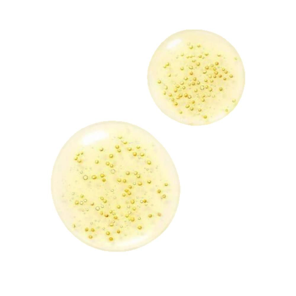 Twee gelige druppels met kleine gouden bolletjes. Op witte achtergrond.