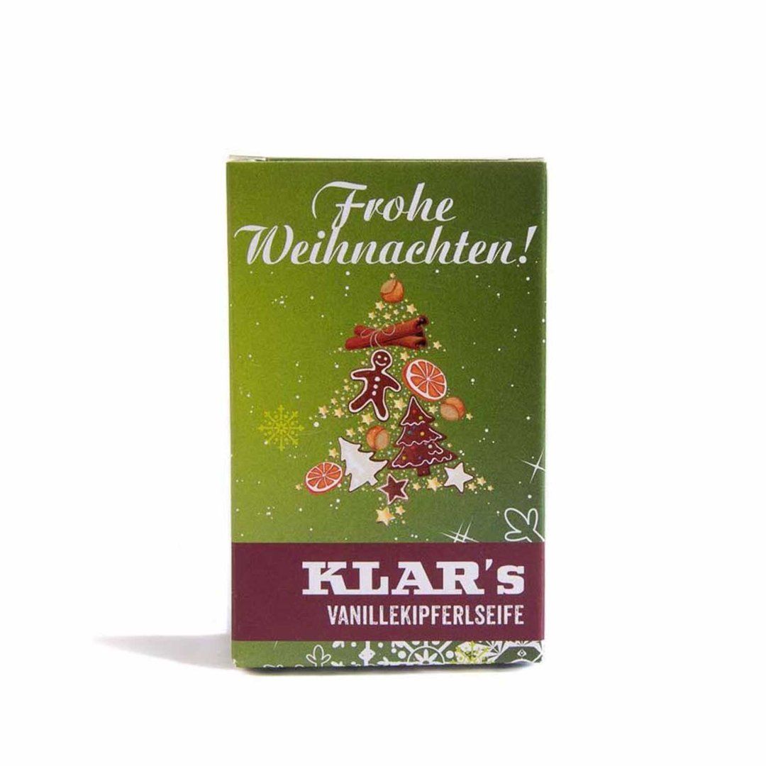Emballage vert avec motif sapin de Noël et inscription "Frohe Weihnachten!". En dessous, "KLAR'S VANILLEKIPFERLSEIFE" est écrit.