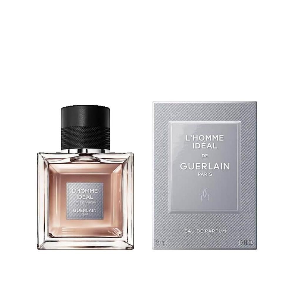 Flacon et emballage Guerlain L'Homme Ideal Eau de Parfum. Flacon carré, bouchon noir, liquide brun clair. Emballage avec logo.