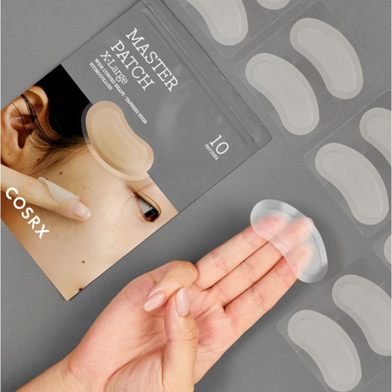 Paquet de patchs anti-acné et patchs individuels. Sur le paquet : MASTER PATCH X-Large. Les patchs sont transparents.