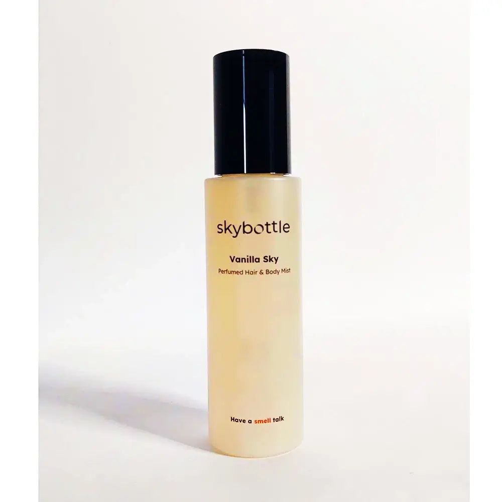 SKYBOTTLE Vanilla Sky, parfum voor haar & lichaam. Cilindrische fles met zwarte dop. Opschrift: Have a small talk.