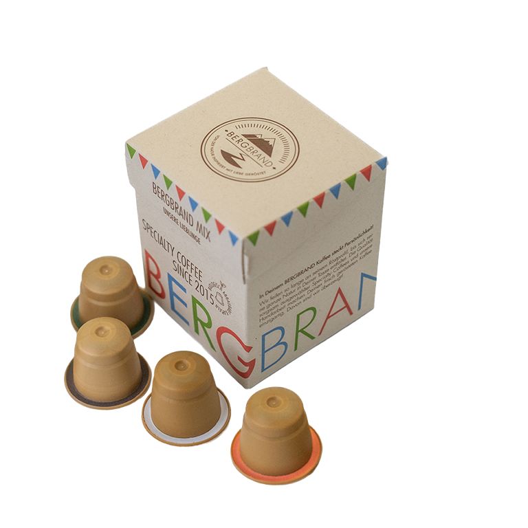 Koffiecapsules en verpakking. Capsules met gekleurde randen. Verpakking met logo en tekst.