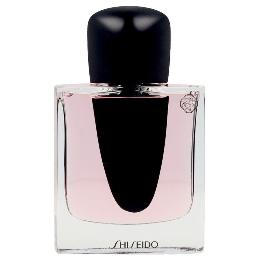 Flacon de parfum avec bouchon noir et liquide rose. Logo Shiseido en bas.