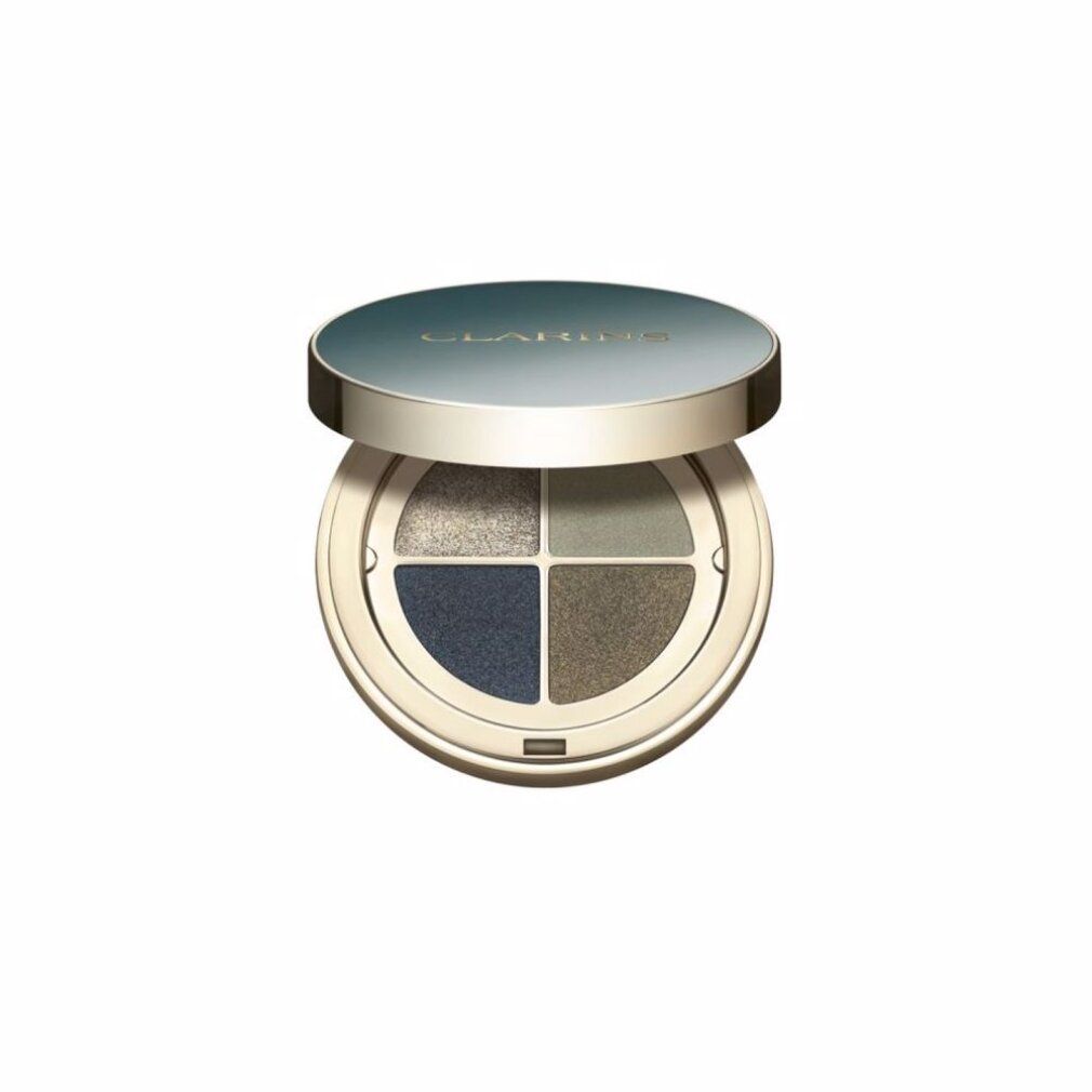 Geopend, rond oogschaduwpalet. Vier kleuren: goud, groen, blauw en bruin. Deksel met opschrift CLARINS.