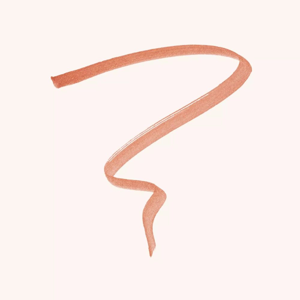Trait d'eyeliner orange sur fond clair. La ligne est incurvée.