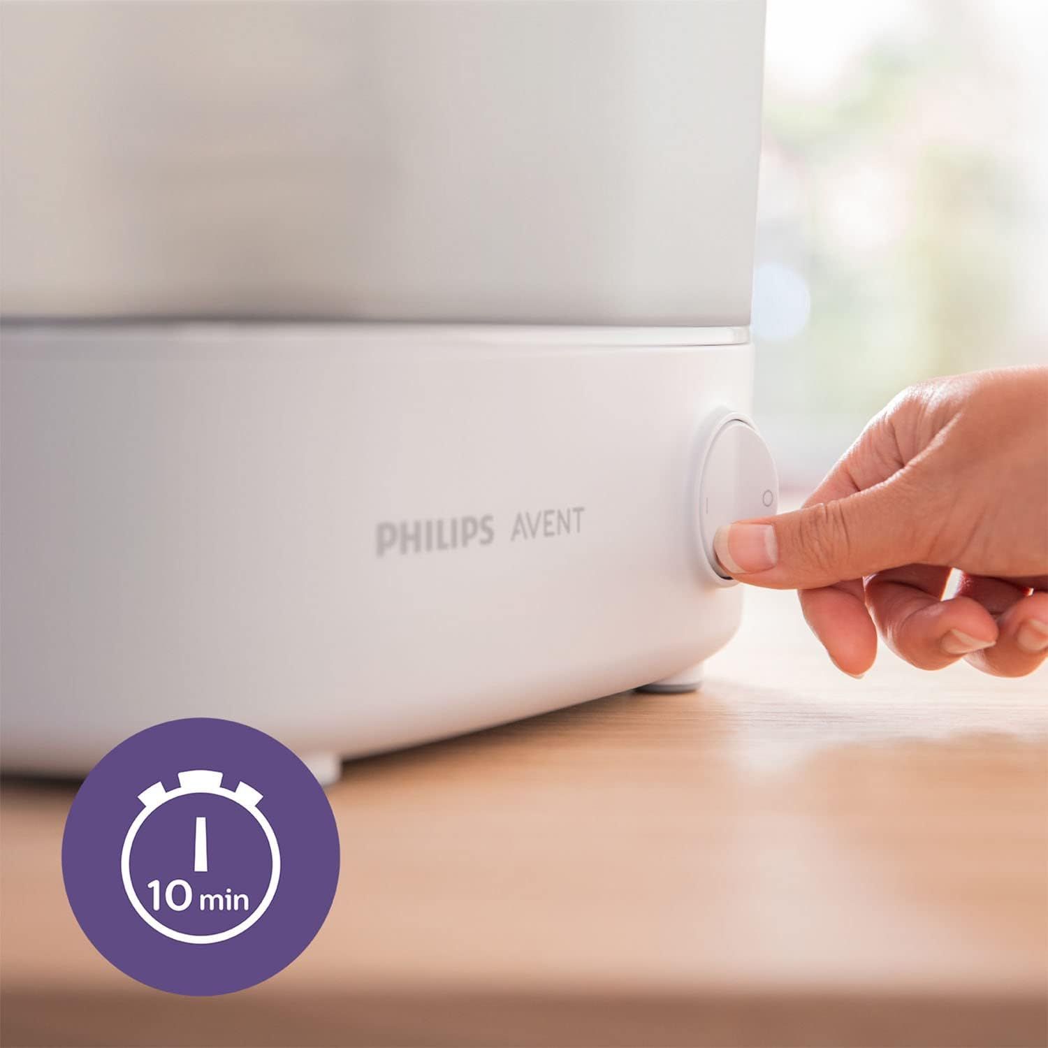Gros plan d'une main appuyant sur le bouton d'un stérilisateur Philips Avent, avec un cercle violet indiquant '10 min'.