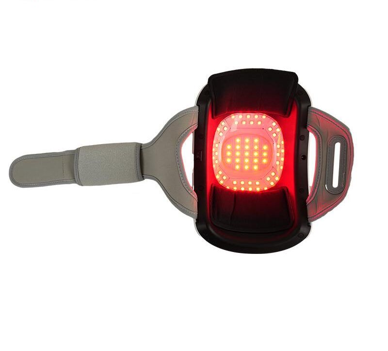 Knie-massageapparaat met rood licht. Rechthoekige vorm met band. Rood lichtveld in het midden.