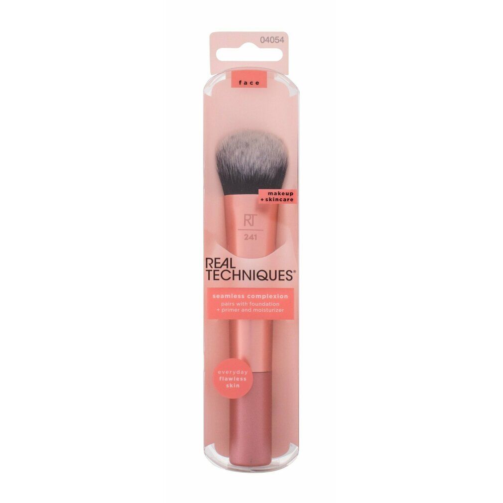 Make-up kwast in verpakking. Roze handvat, grijs-zwarte borstelharen. "REAL TECHNIQUES" staat erop.