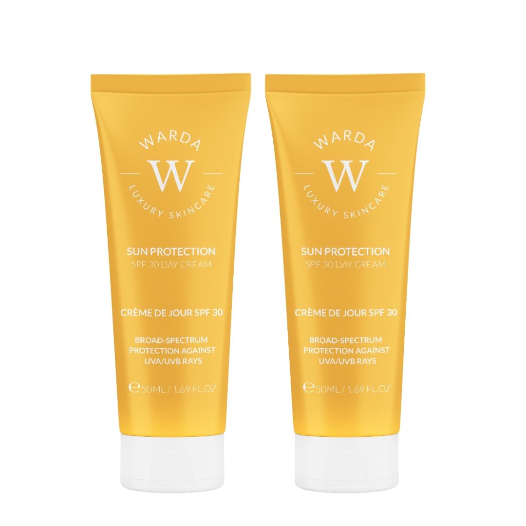 Twee gele tubes met witte dop. Zonnebrandcrème SPF 30. Gouden logo en tekst. E50ml/1.69 fl.oz.