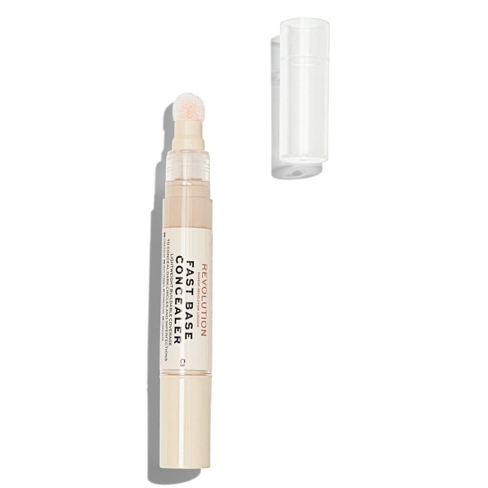 Concealer beige avec applicateur éponge et bouchon transparent. Inscription: Fast Base Concealer.